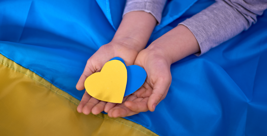 kids-hands-holding-yellowblue-paperhearts-on-ukrainian-flag-background 1